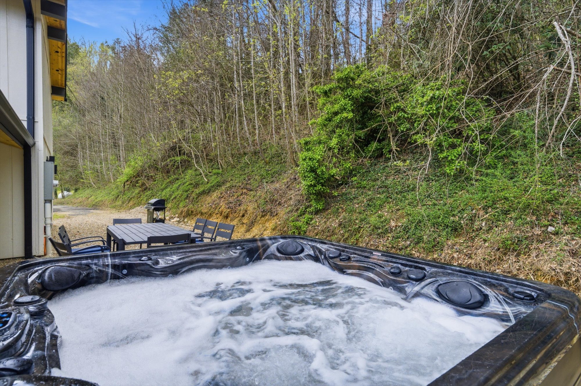 Outdoor hot tub with wooded views